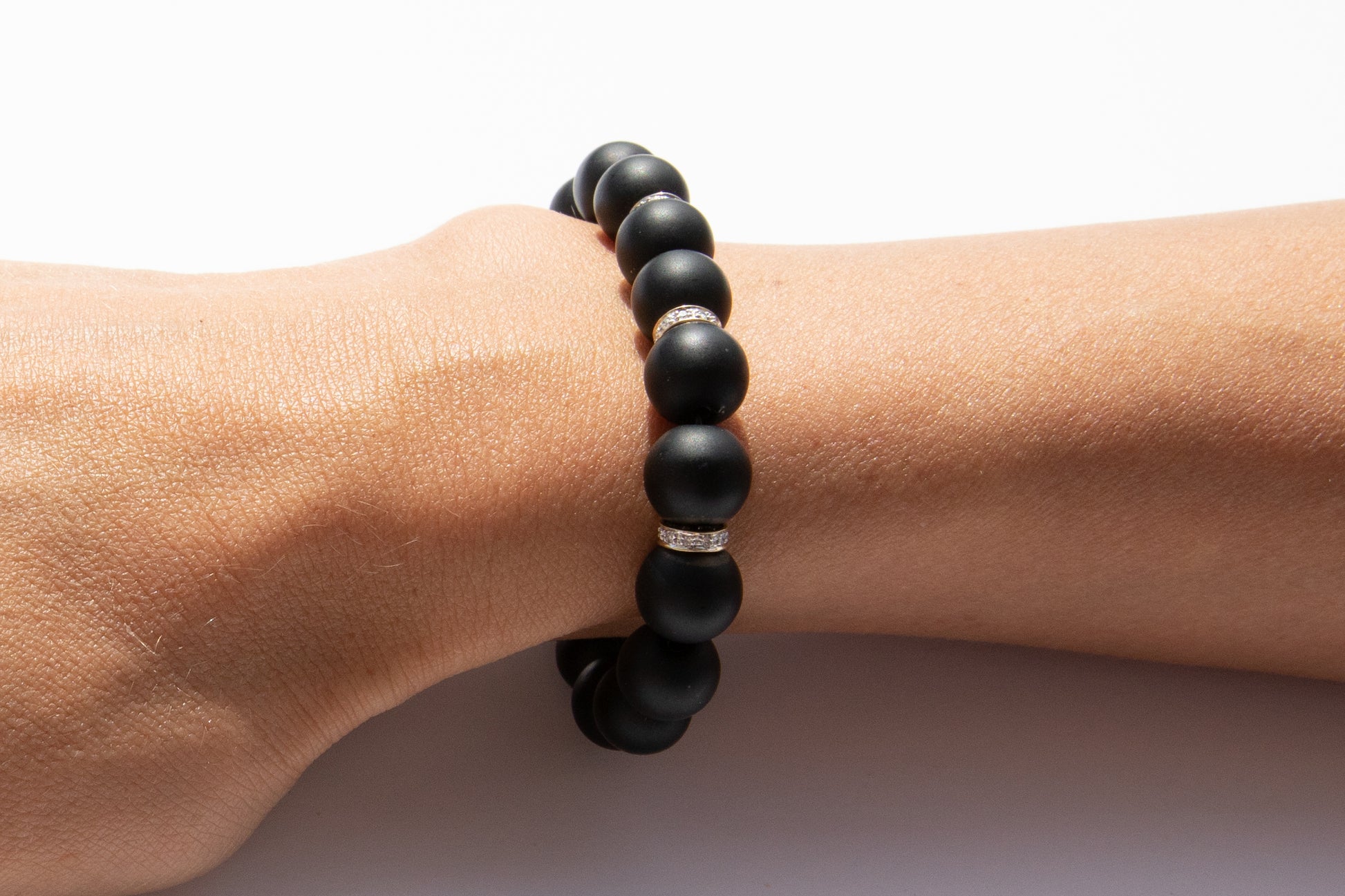 Black Onyx Beaded Bracelet With Three Pavé Diamond Spacer Beads Set in 14k Gold Pictured On Arm