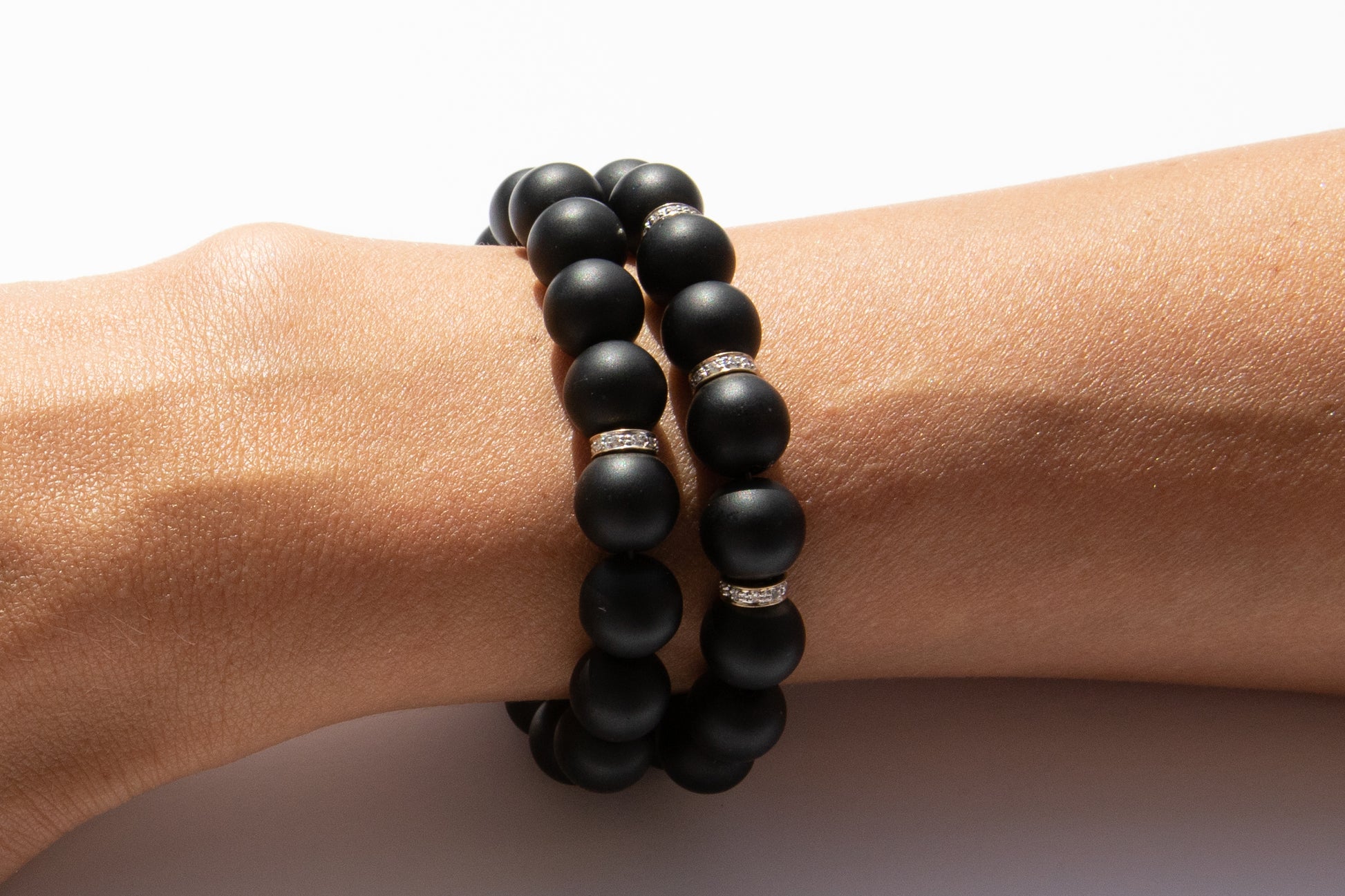 Set of Two Black Onyx Beaded Bracelet With Three Pavé Diamond Spacer Beads Set in 14k Gold Pictured On Arm