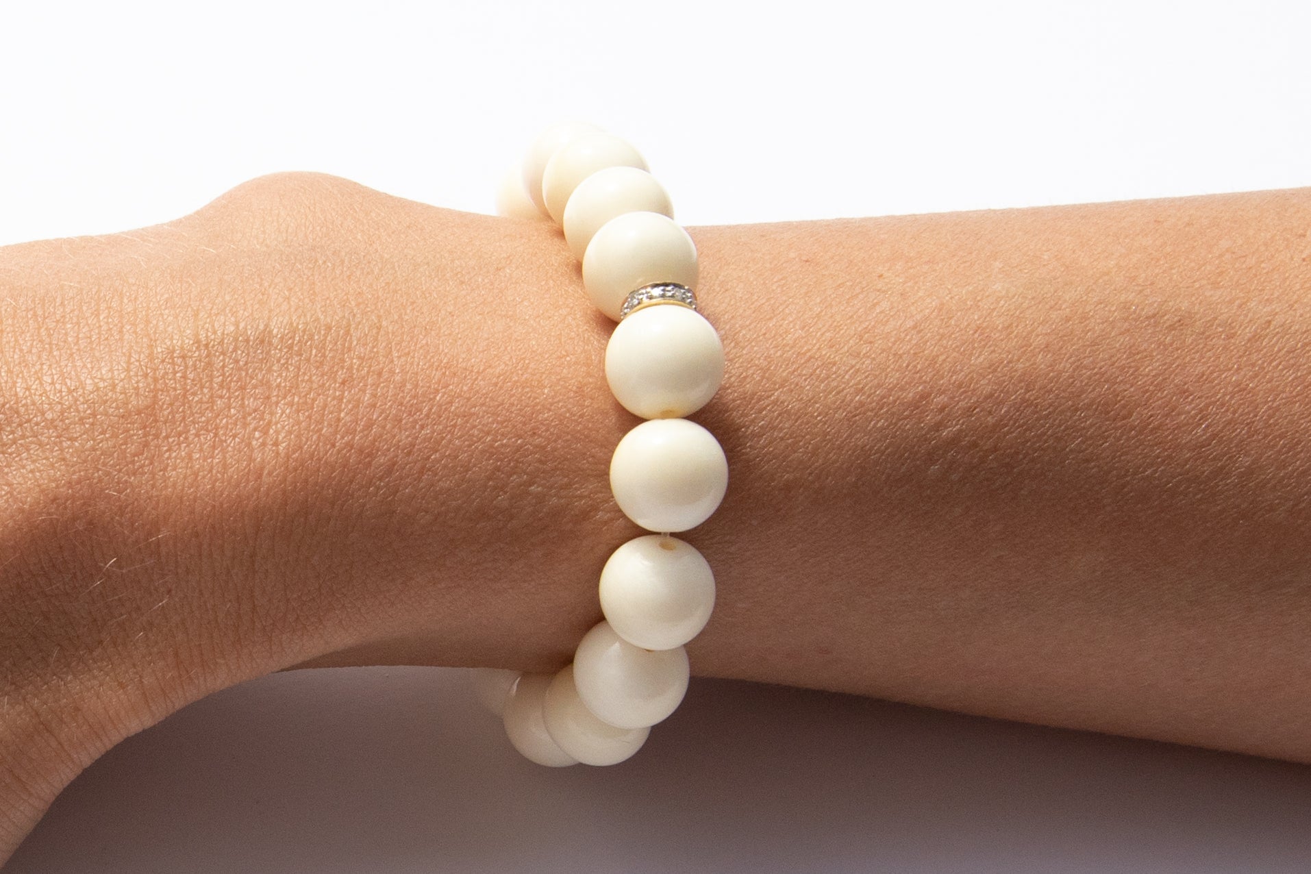 White Bone Beaded Bracelet With Pavé Diamonds Set in 14k Yellow Gold Featured on Arm